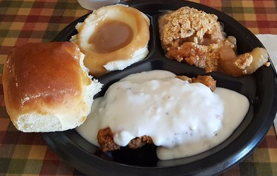 Golden brown hand-breaded chicken tenders on a plate at Pick-O-Deli